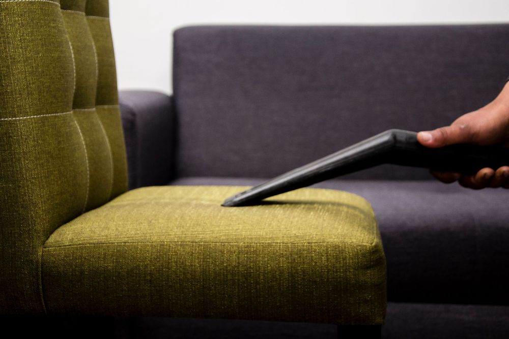 Upholstery being cleaned on a fabric sofa
